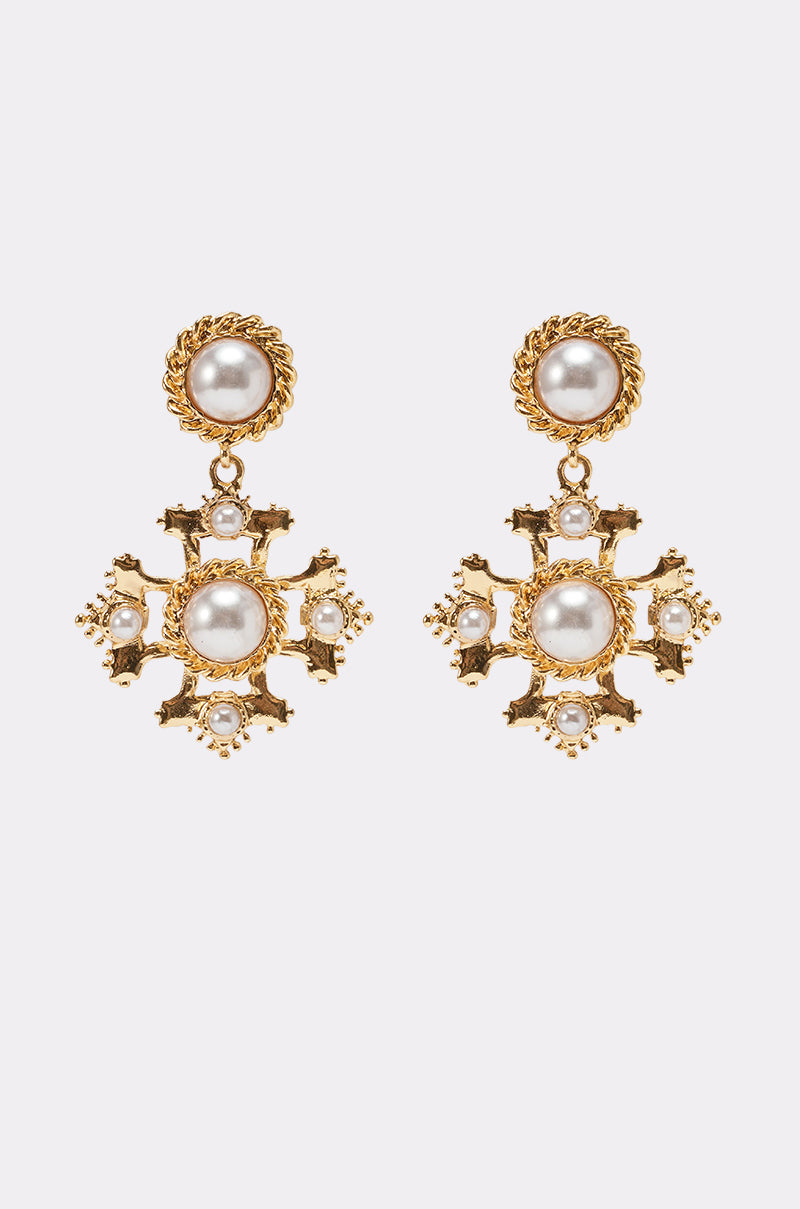 The CROSS MY HEART EARRING is an ornate gold drop earring with large central pearls, intricate detailing, and smaller pearls, evoking the elegance of a pearl stud against a plain white background. 0