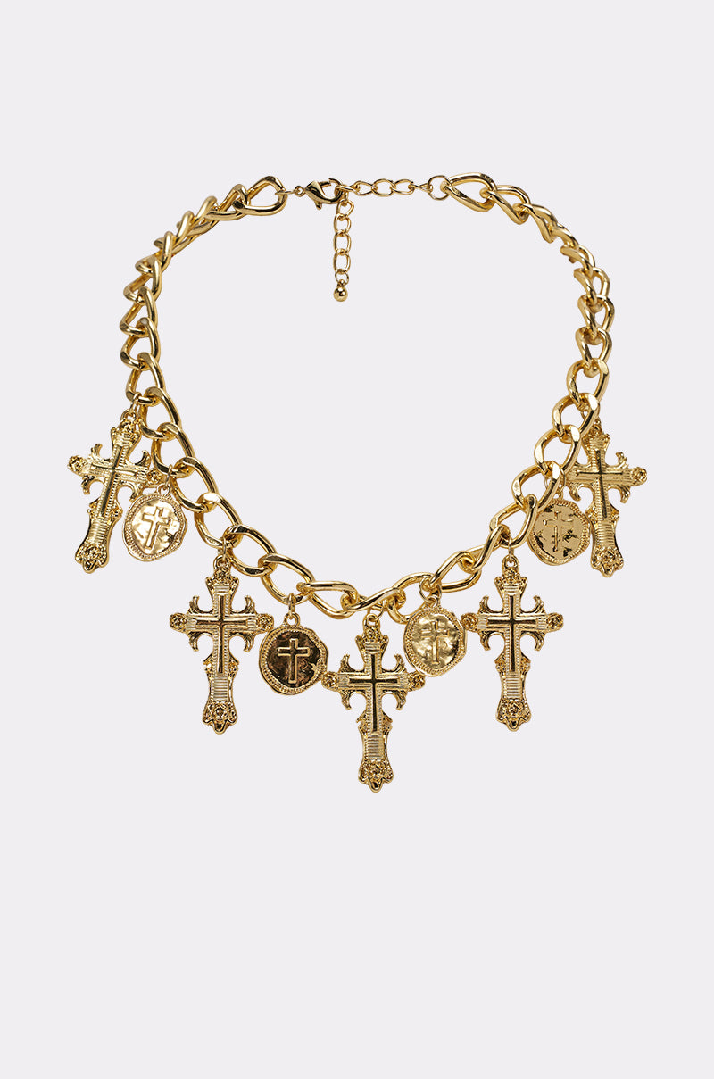 The CHARMED LIFE NECKLACE features large interlocking gold links with five ornate cross pendants and three round medallion charms—ideal for chunky chain jewelry lovers, displayed on a plain white background. 3