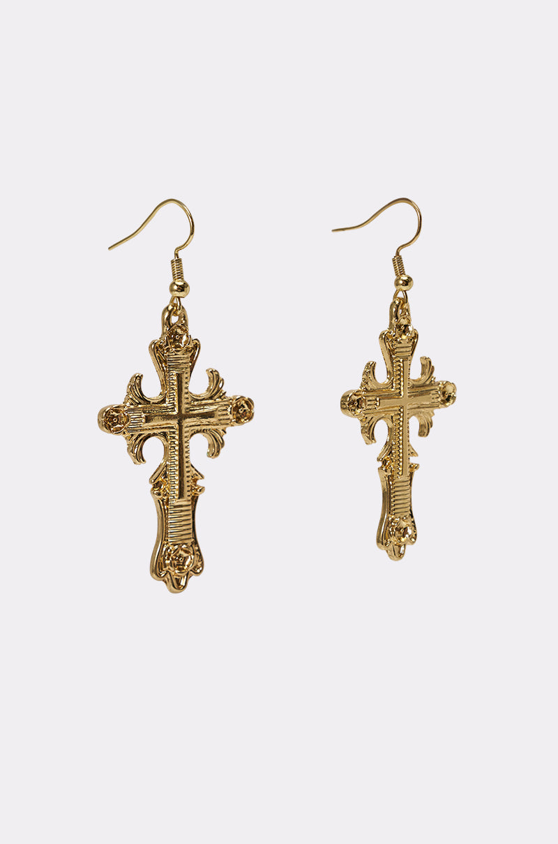 The CHARMED LIFE NECKLACE features an ornate gold cross pendant with intricate detailing, displayed on a plain light background for a striking statement look. 6