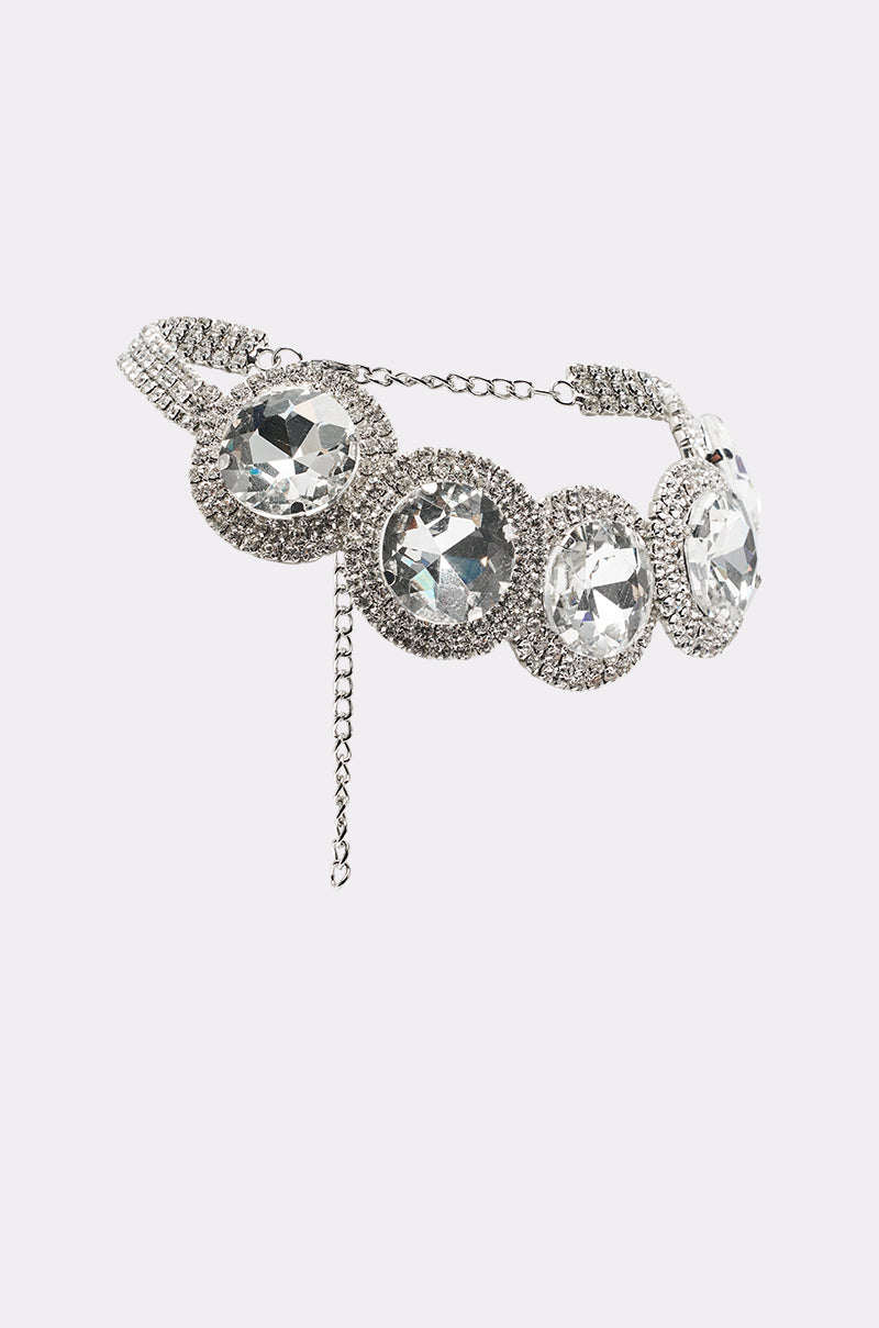 The AT THE BALL CHOKER is a sparkling silver necklace with four large oval rhinestones surrounded by smaller crystals and an adjustable chain clasp—an elegant accessory for eveningwear. 3