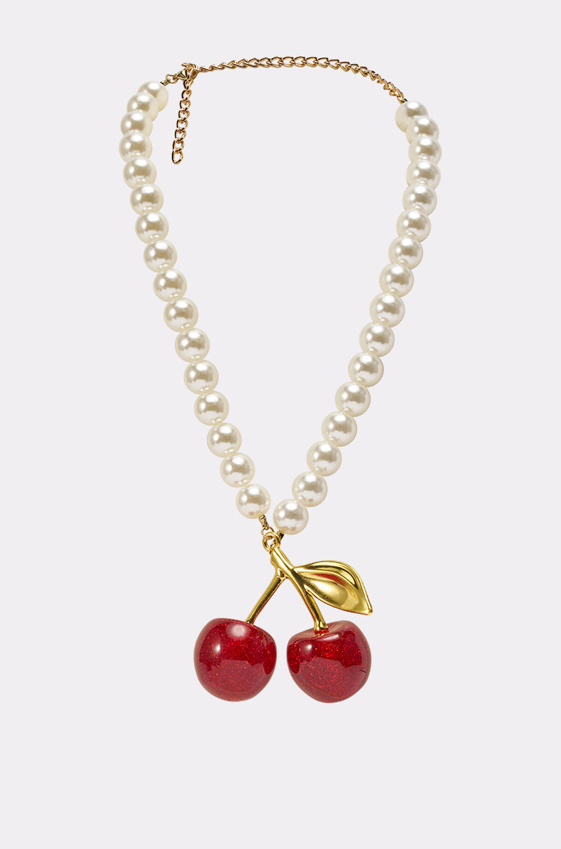 The POP MINE NECKLACE features lustrous white pearls on a gold chain, decorated with two shiny red cherries and a gold leaf—making this whimsical piece a charming statement accessory for any outfit. 1