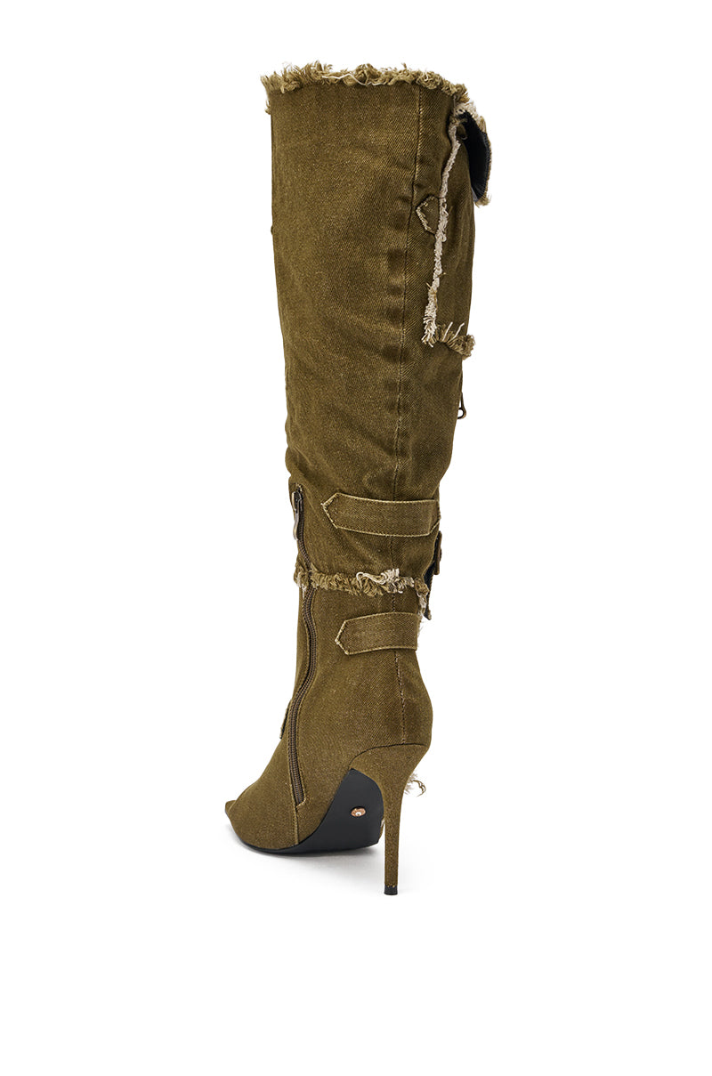 The AKIRA GOLD NADAL OLIVE CANVAS OPEN TOE STILETTO BOOTIE is displayed in a side view, featuring an open toe, stiletto heel, olive canvas material, and decorative details against a white background. 5