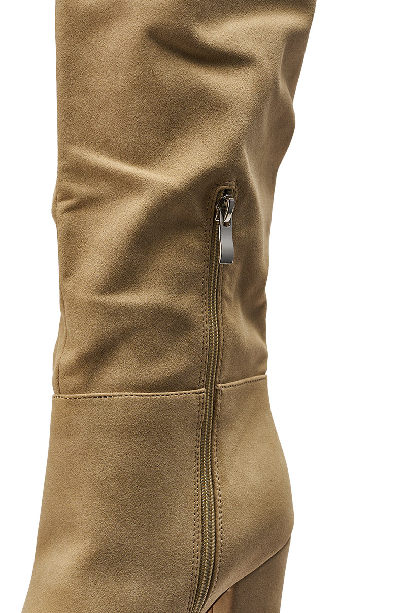 A close-up of the AZALEA WANG NANETTE Taupe Slouchy Boot in faux suede, showcasing a side zipper, visible stitching, and part of the chunky heel against a white background.