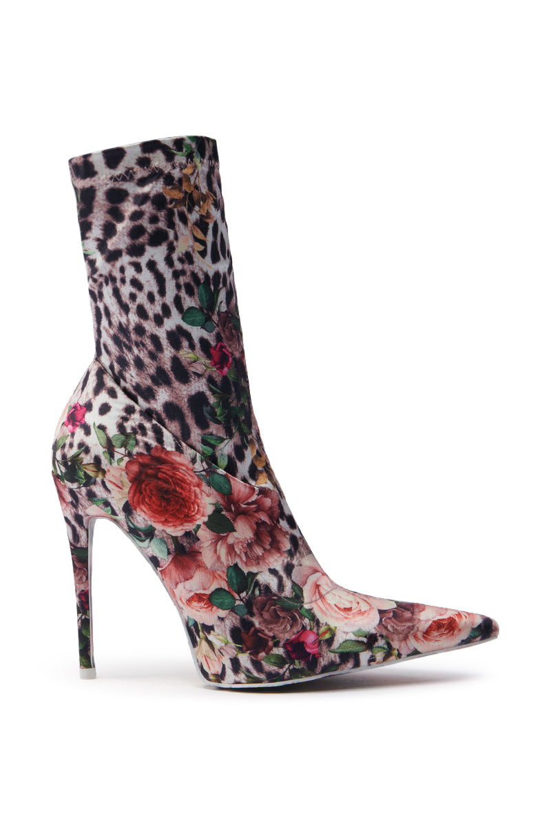 The AZALEA WANG NARCISSUS MULTI FLORAL AND LEOPARD BOOTIE features a satin textile upper with vibrant floral and leopard patterns, complete with a pointed toe and stiletto heel for a chic style.