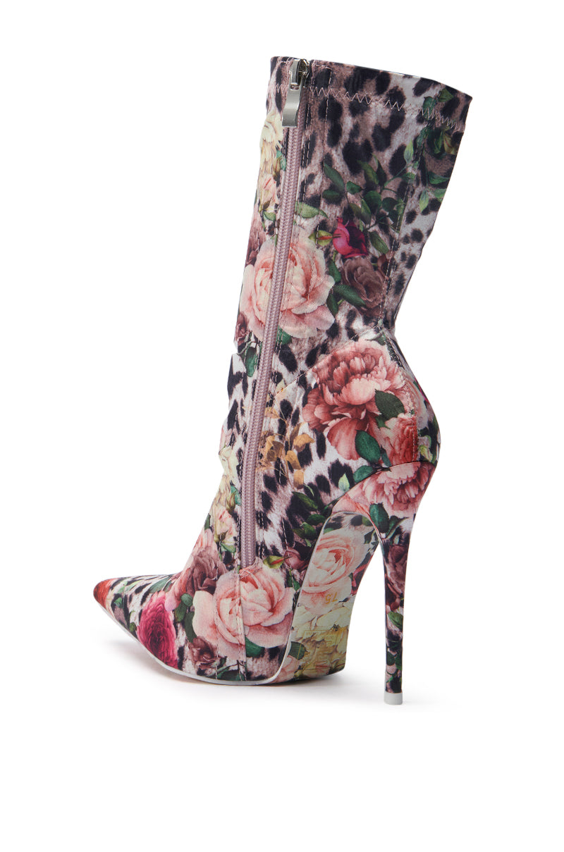 The AZALEA WANG NARCISSUS MULTI FLORAL AND LEOPARD BOOTIE is a striking high-heeled bootie featuring a pointed toe, vibrant leopard and floral satin pattern, sleek side zipper, and an elegant stiletto heel.