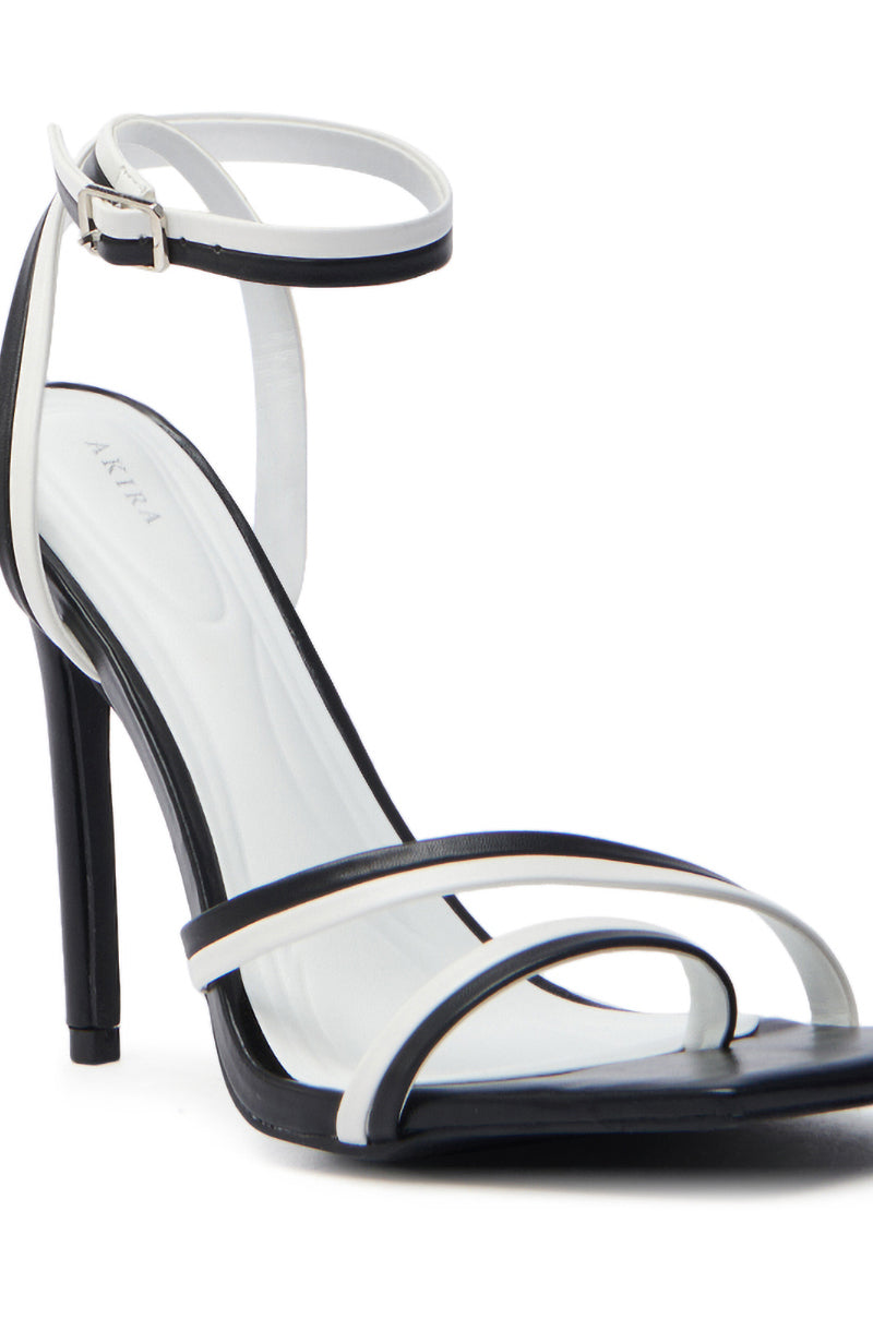 The AKIRA NEHARA BLACK AND WHITE STILETTO SANDAL features an open square toe, slim ankle strap with buckle, and sturdy stiletto heel. Its minimalist look includes two thin crossing front straps made from vegan leather and a contrasting white insole.