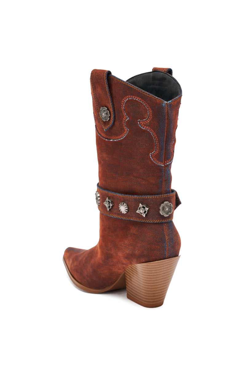 The AZALEA WANG NEITH burnt orange denim western bootie features decorative stitching, metal studs, an ankle strap, and a chunky heel, shown from a rear side angle on a white background.