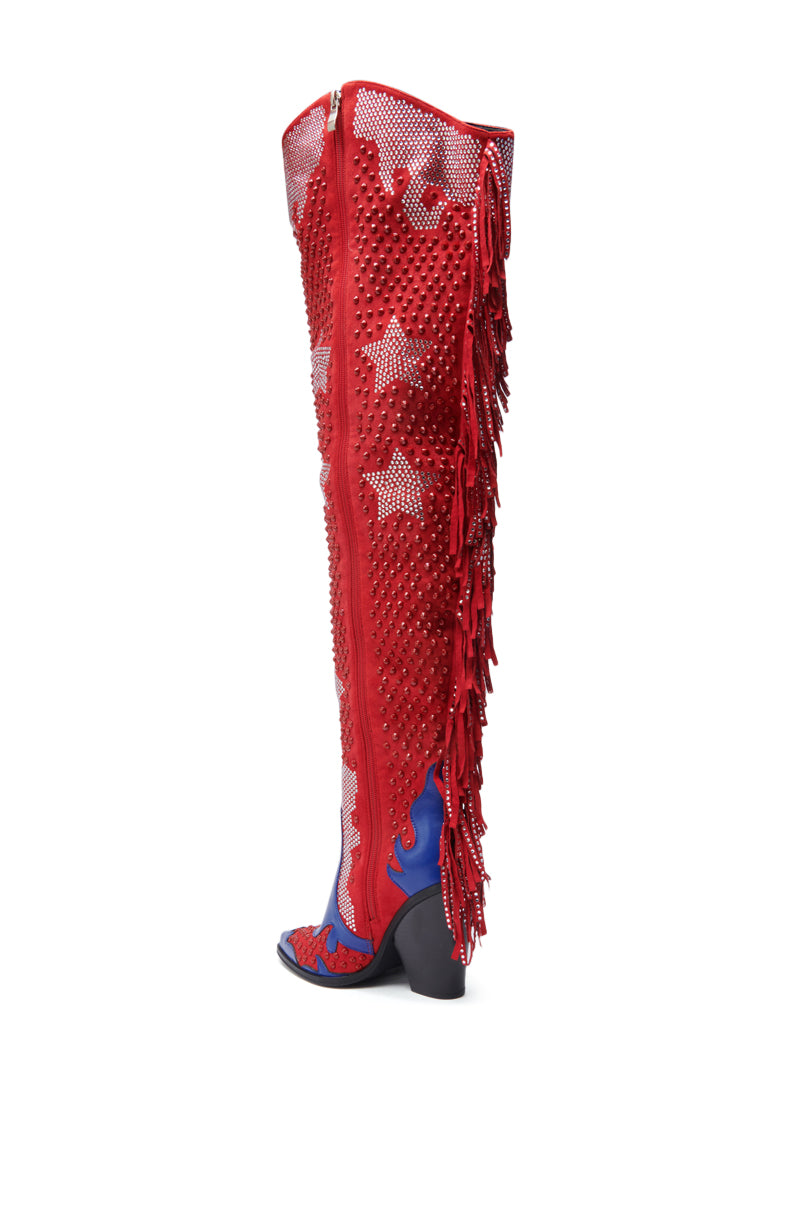 The AZALEA WANG NELLA BLUE MULTI WESTERN EMBELLISHED BOOT is a bold, knee-high faux suede design featuring white stars, blue accents, red side fringe, small studs, sparkling rhinestones, and a chunky black heel.