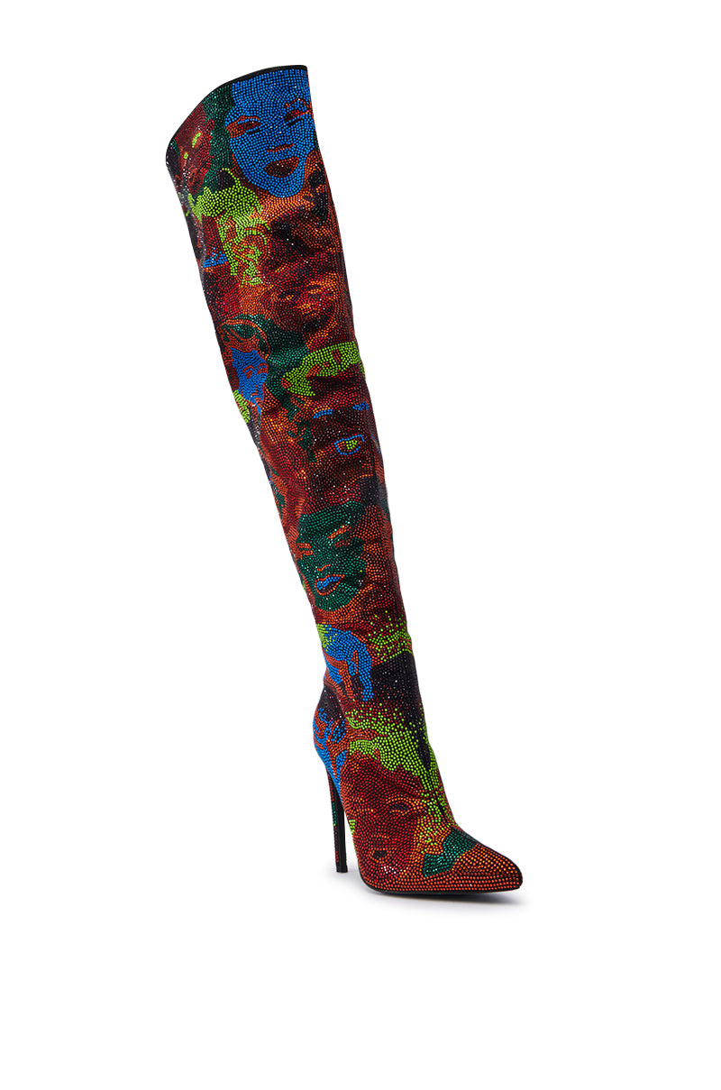 Introducing the AZALEA WANG NERISSA MULTI STILETTO THIGH HIGH BOOTS, rhinestone-adorned footwear that extends over the knee. These boots flaunt a vibrant and striking abstract pattern featuring faces in hues of red, blue, green, and black. The design is completed with a pointed toe and high heel.