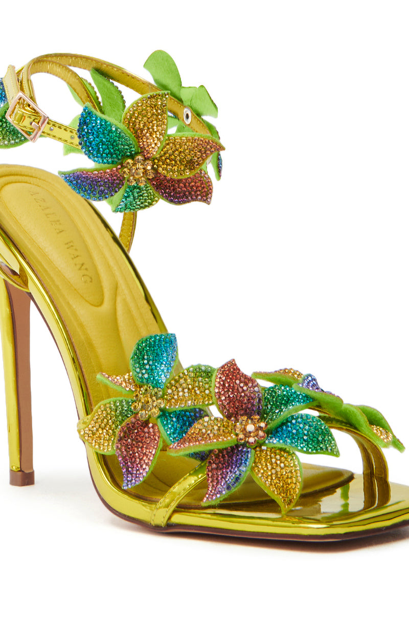 The AZALEA WANG NERIYA MULTI RHINESTONE FLOWER STILETTO SANDAL features shiny yellow-gold metallic faux leather, beaded flower decorations in blue, green, orange, and purple with vibrant leaf designs and a thin heel for added sophistication.