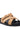 The AZALEA WANG NESSAROSE Tan Faux Suede Sandal sports a wide crisscross strap with a gold buckle on a black flatform sole. It features an open toe design and flat heel, providing a casual and stylish appeal.