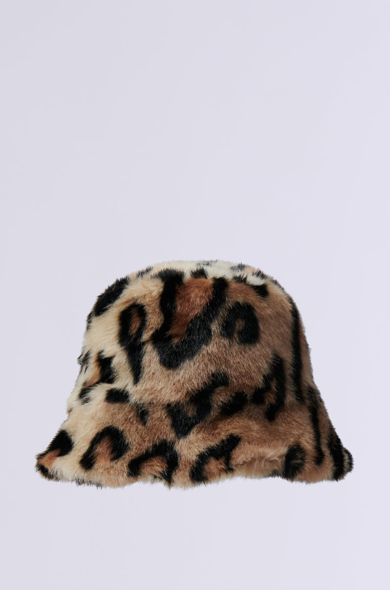 The SISTA SISTA Cheetah Bucket Hat is displayed elegantly against a plain white background. This trendy accessory features a soft faux fur texture with beige, black, and brown patterns that emulate wild animal prints.