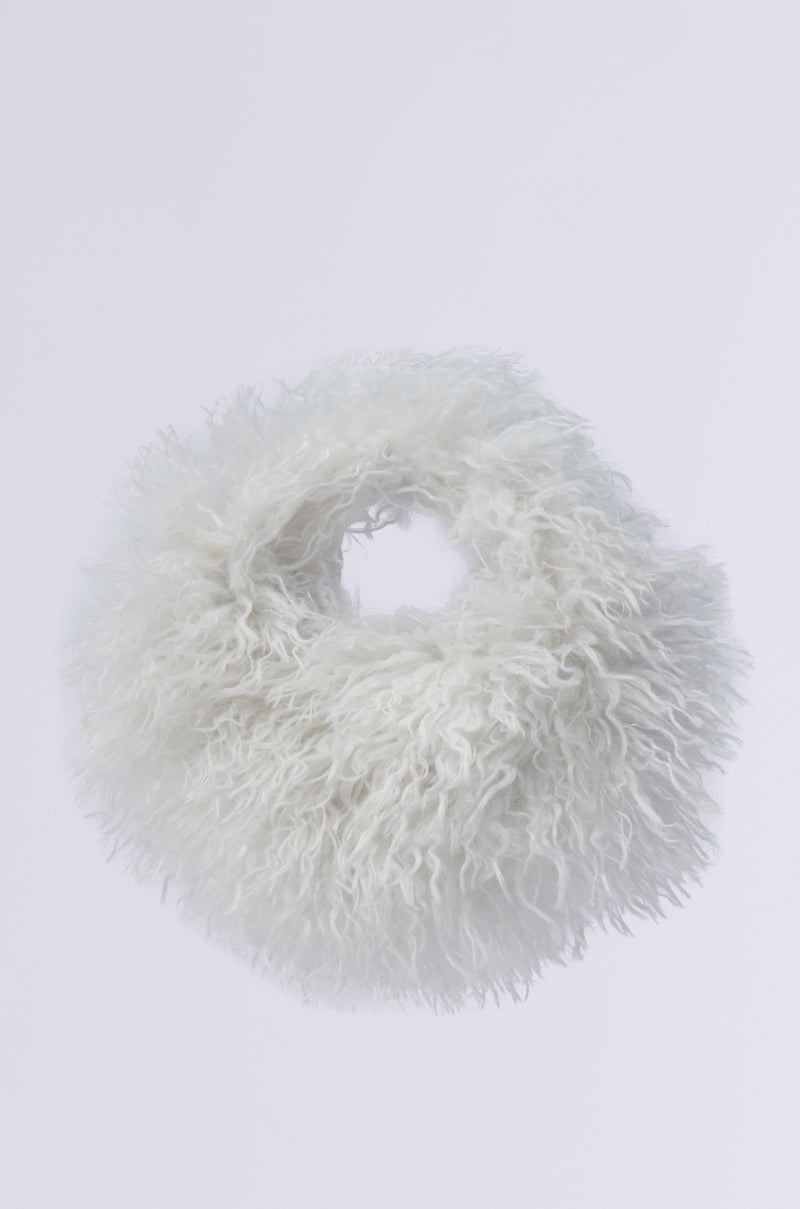 A round, fluffy white IN A FLURRY FAUX FUR BAG with a shaggy texture, resembling soft wool. Perfect as a holiday party accessory, this faux fur delight sits elegantly against a plain white background.