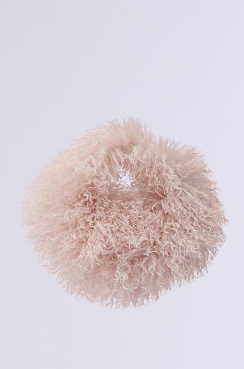 A plush, circular wall piece crafted with shaggy faux fur featuring curly pink fibers on a light gray backdrop, echoing the whimsical and fluffy texture of a CURLY Q FAUX FUR PURSE.