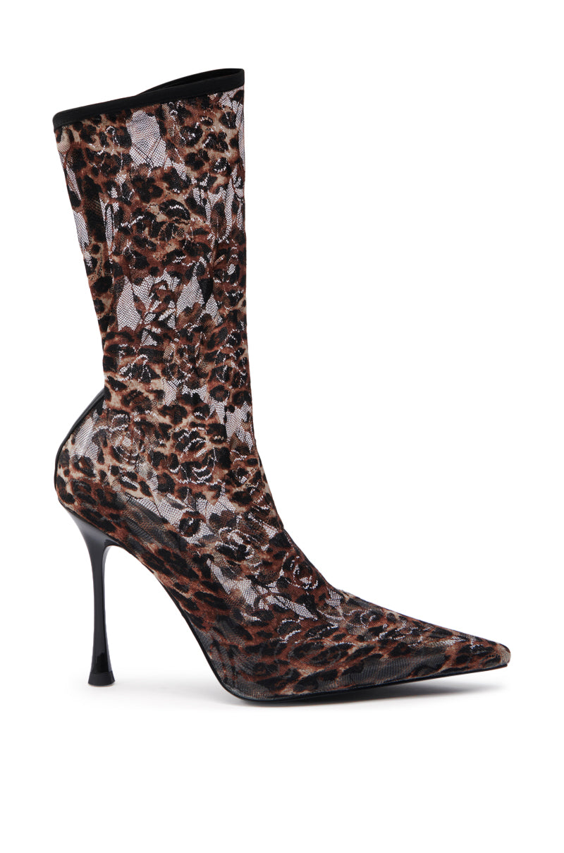 The AZALEA WANG NICKLAS LEOPARD STILETTO BOOTIE features a high heel, pointed toe, slim stiletto heel, brown/black/white leopard print, and a fitted mid-calf shaft.