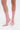 A person wearing the AZALEA WANG NICKLAS PINK LEOPARD STILETTO BOOTIE, featuring a pointed toe and sheer mesh upper, stands on a white background.