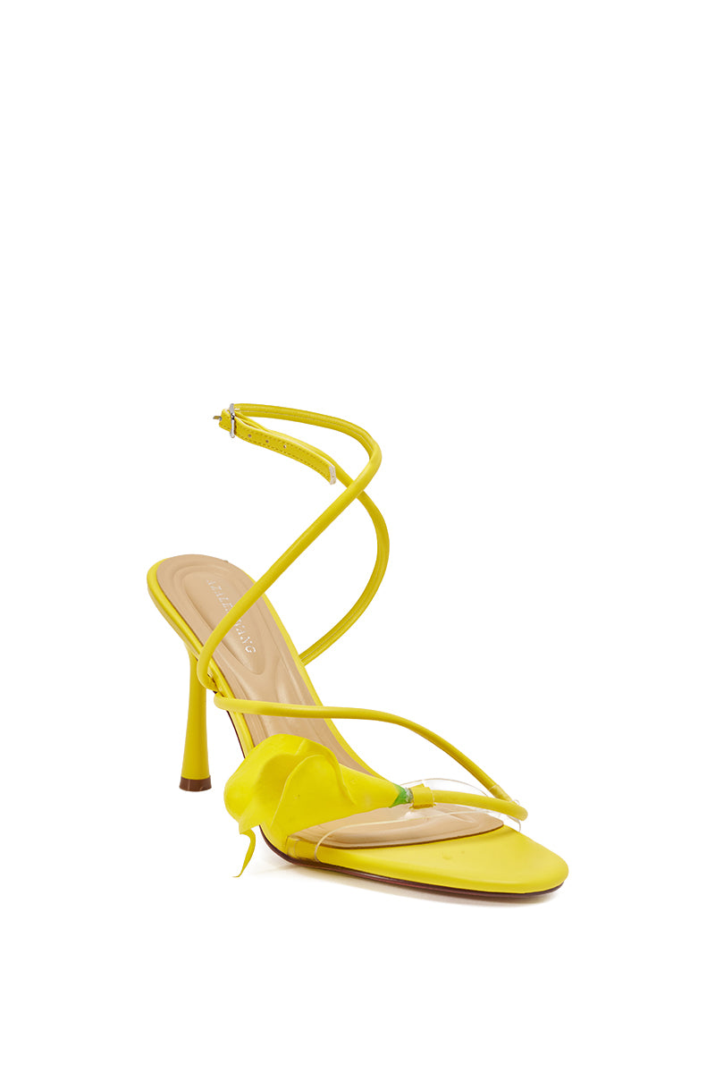 The AZALEA WANG NILOU YELLOW FLORAL DECALE STRAP STILETTO SANDAL features thin straps, a stiletto heel, a wrap-around ankle strap, an open toe, and a decorative flower accent on the side. 6