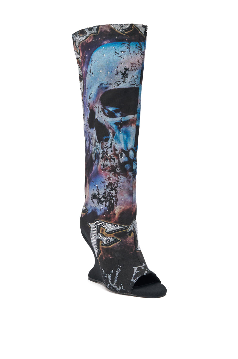The AKIRA GOLD NINE LIVES GRAPHIC OPEN TOE WEDGE BOOT is a knee-high statement piece featuring a sculpted wedge heel, vibrant abstract designs in dark tones, an eye-catching blue skull, and a bold open toe for an edgy look.