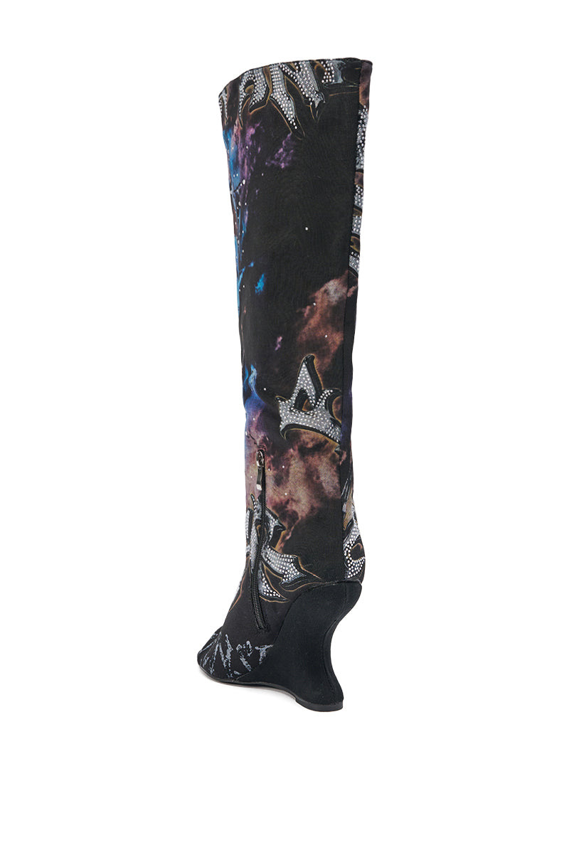 The AKIRA GOLD NINE LIVES GRAPHIC OPEN TOE WEDGE BOOT is knee-high with a curved wedge heel, features a bold multicolored cosmic print, and is embellished with silver fleur-de-lis accents.