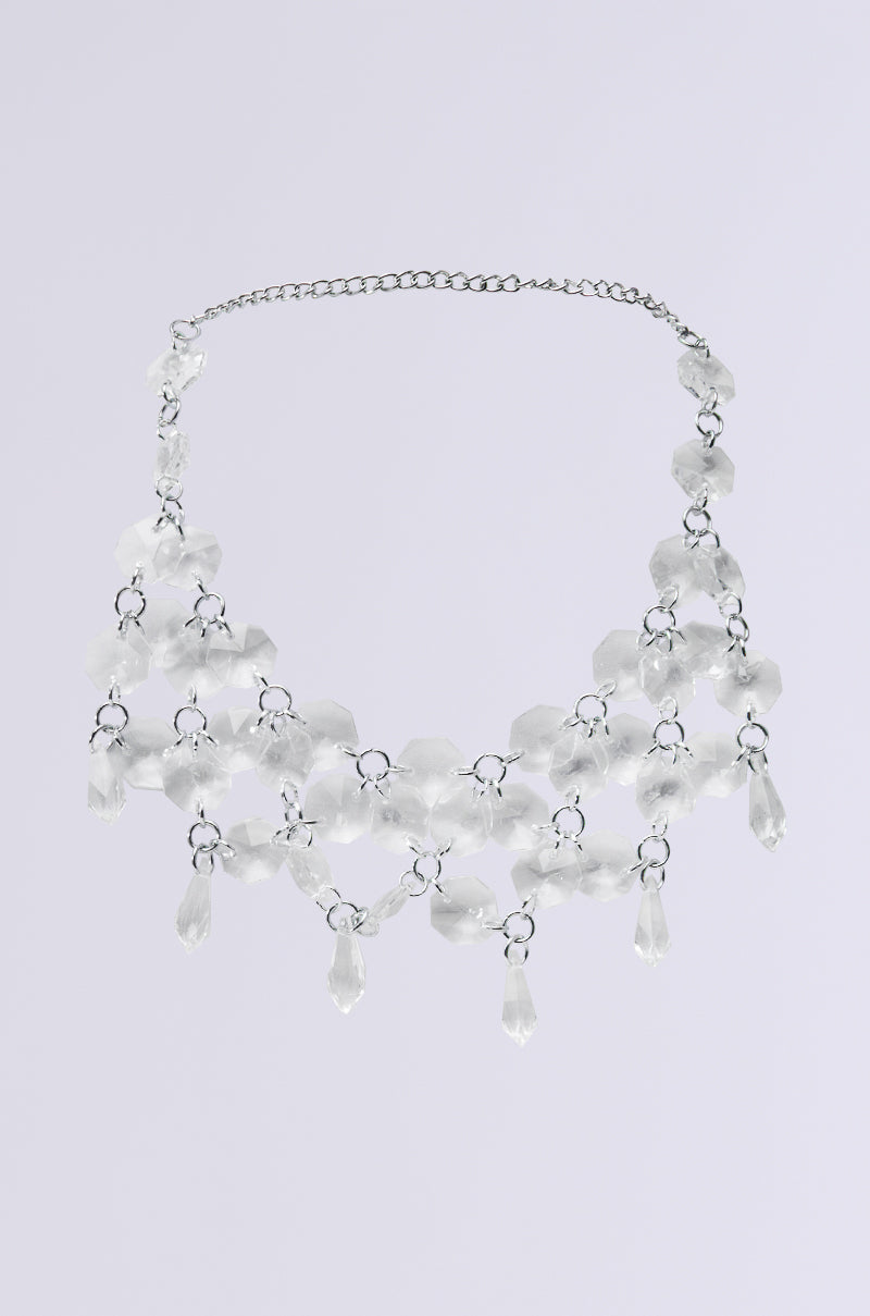 Meet the FANTASY DRIP CHOKER: a silver necklace with adjustable clasp, featuring multiple strands of clear crystal-like beads and teardrop pendants. This elegant piece sparkles beautifully on a plain background, combining style and versatility.