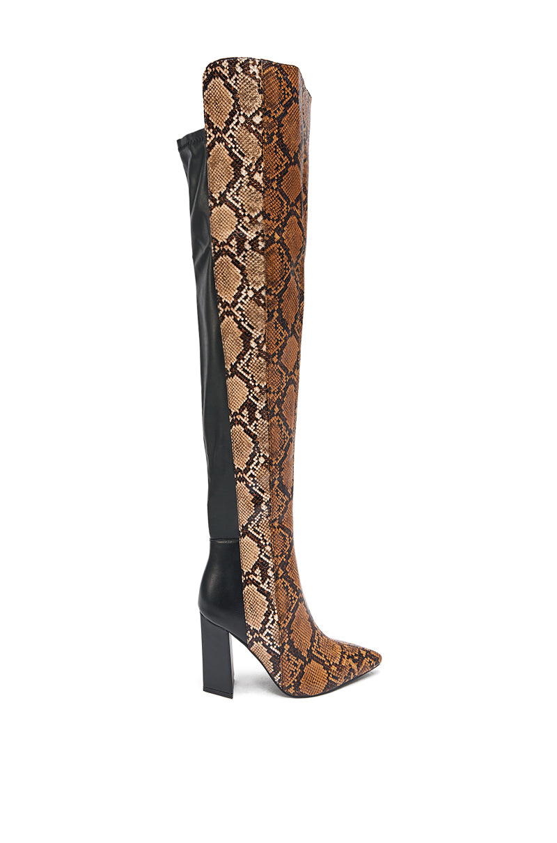 The AKIRA GOLD NOAMI MULTI SNAKE PRINT CHUNKY HEEL BOOT features a brown snakeskin print on the front and side, black faux leather on the back, and a pointed toe—a bold, statement-making fashion choice.