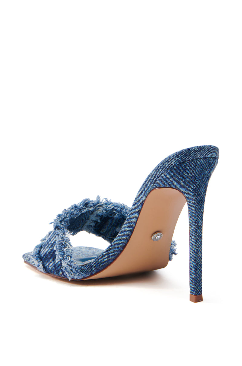 The AZALEA WANG NOBURO DENIM STILETTO SANDAL features a single high-heeled shoe with an open toe and slim stiletto. Crafted from acid wash denim, it has beige sole and heel tips with metallic accents, exuding chic denim style.