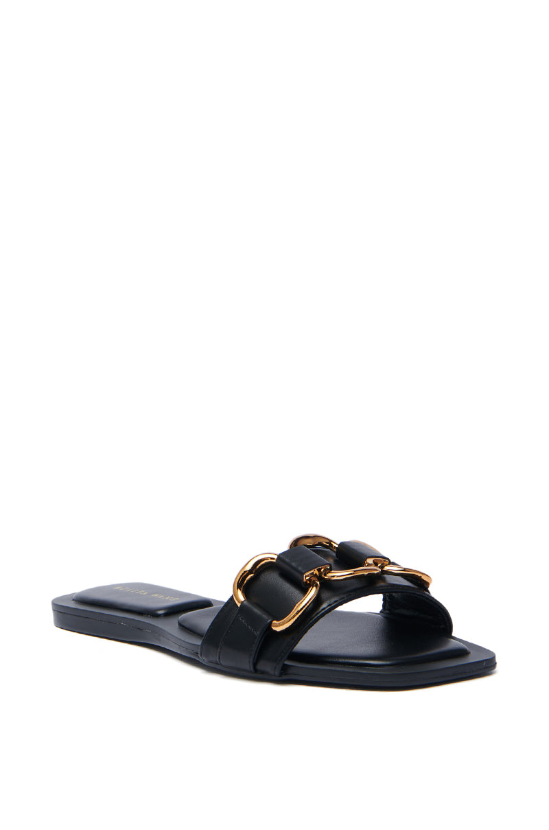 The AKIRA NOELINE black slip-on sandal features a flat sole, an open-toe design, and two parallel faux leather straps with gold hardware accents for a minimalist look.