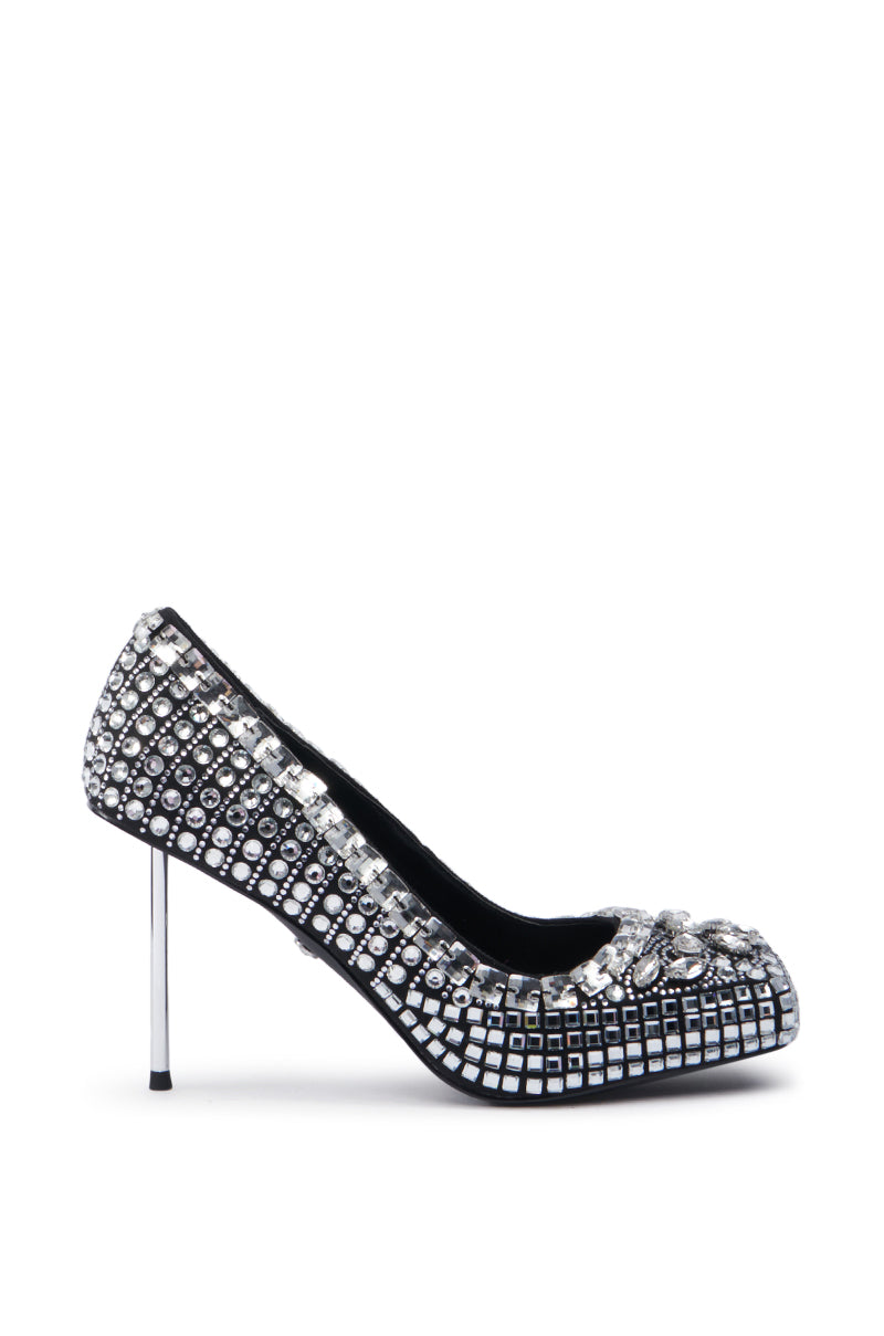 The AZALEA WANG NOOMI BLACK PUMP dazzles with small square and round jewels, making it perfect for a night out. This rhinestone stiletto features a pointed toe and slim heel, effortlessly combining elegance and glamour.
