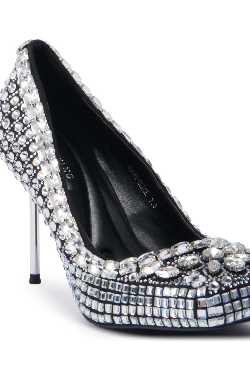 A close-up of the captivating AZALEA WANG NOOMI BLACK PUMP, adorned with shimmering silver sequins and gemstones. This elegant stiletto showcases a pointed toe and a sleek metallic heel, radiating sophistication from every perspective.
