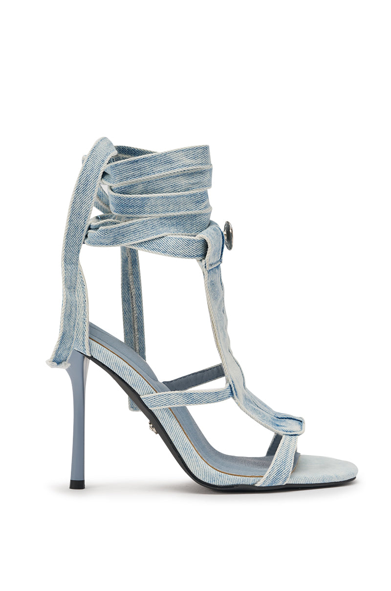 The AKIRA GOLD NORMA JEAN DENIM STRAPPY STILETO SANDAL features light blue denim, multiple straps, wrap-around ties, an open toe, and a denim stiletto heel for a modern take on classic ankle-strap heels. 3