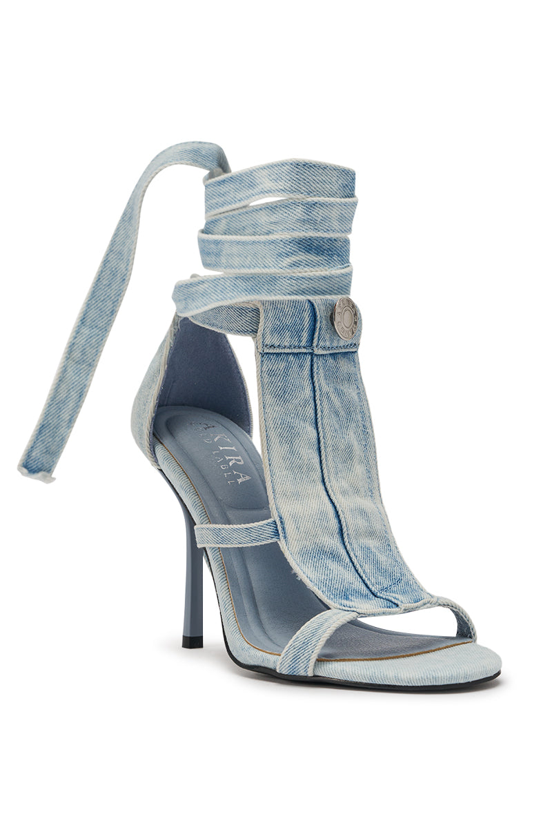 The AKIRA GOLD NORMA JEAN DENIM STRAPPY STILETTO SANDAL features light-wash denim styling, a slim black stiletto heel, wraparound ankle straps, button detail, and open toes for an effortlessly chic look. 4