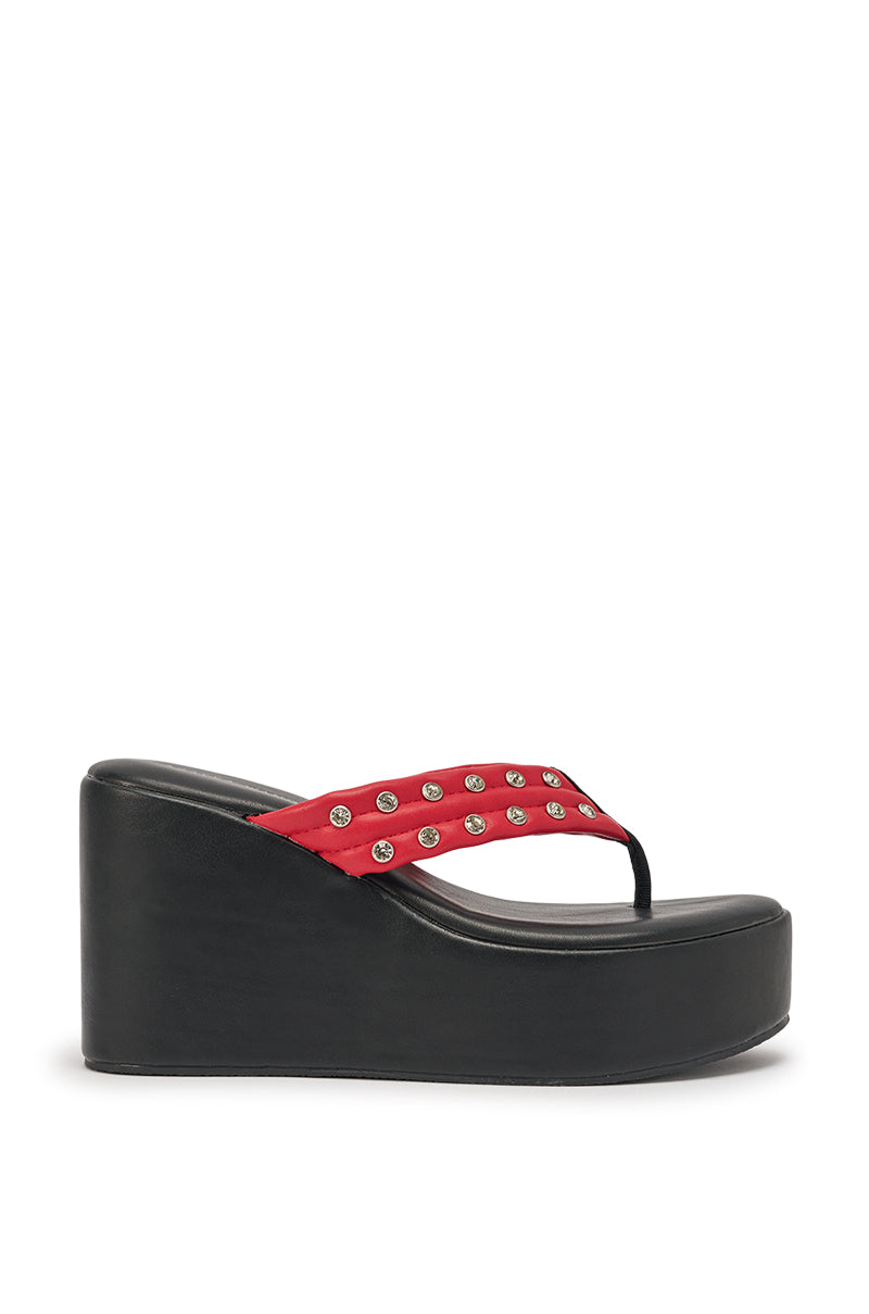 The AZALEA WANG NOVELLE BLACK AND RED STUD EMBELLISHED PLATFORM SANDAL features a black wedge, red thong strap with silver studs, and is shown in side profile against a white background for bold style. 3