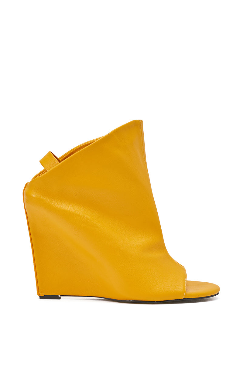 The AZALEA WANG NOVIS YELLOW WEDGE BOOTIE is a yellow faux leather peep toe bootie with a high angular wedge heel, open toe, back strap, and comfort cushion insole, shown on a white background. 3