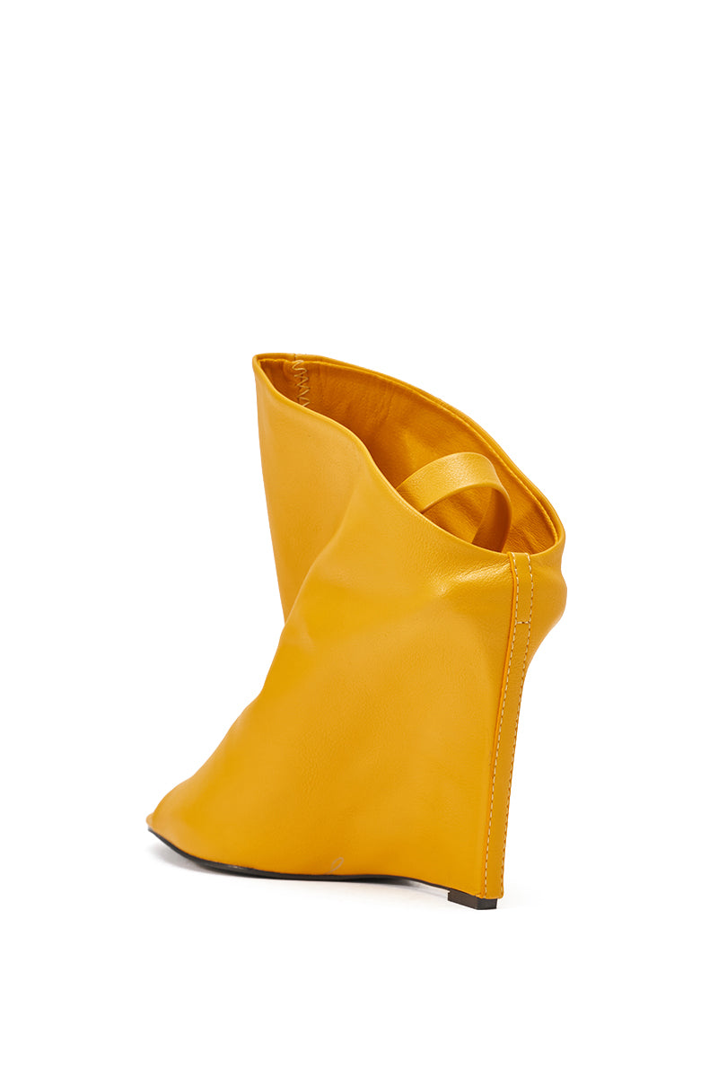 The AZALEA WANG NOVIS YELLOW WEDGE BOOTIE features a sculptural peep toe design, wide slouchy upper, and comfort cushion insole, showcased against a white background. 5