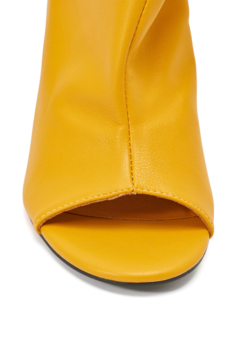 Close-up of the AZALEA WANG NOVIS YELLOW WEDGE BOOTIE, featuring a peep toe front in smooth yellow leather with visible center stitching. 6