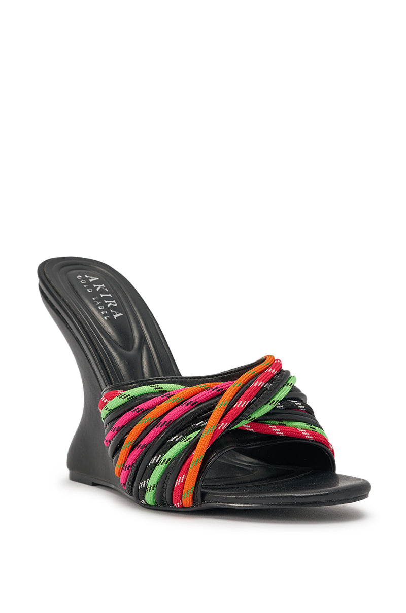 The AKIRA GOLD NOWITZKI MULTI WEDGE AND SHOE LACE SANDAL features a black faux leather design, sculptural wedge heel, and multicolored crisscross shoe laces in red, green, pink, yellow, and orange. Insole labeled "Akira Collection. 4