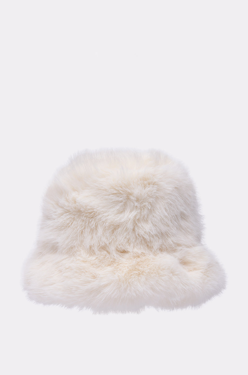 The BABY IT'S COLD OUTSIDE FAUX FUR BUCKET HAT IN IVORY is shown against a light background, highlighting its soft texture and making it a perfect, cozy accessory for your winter wardrobe. 5