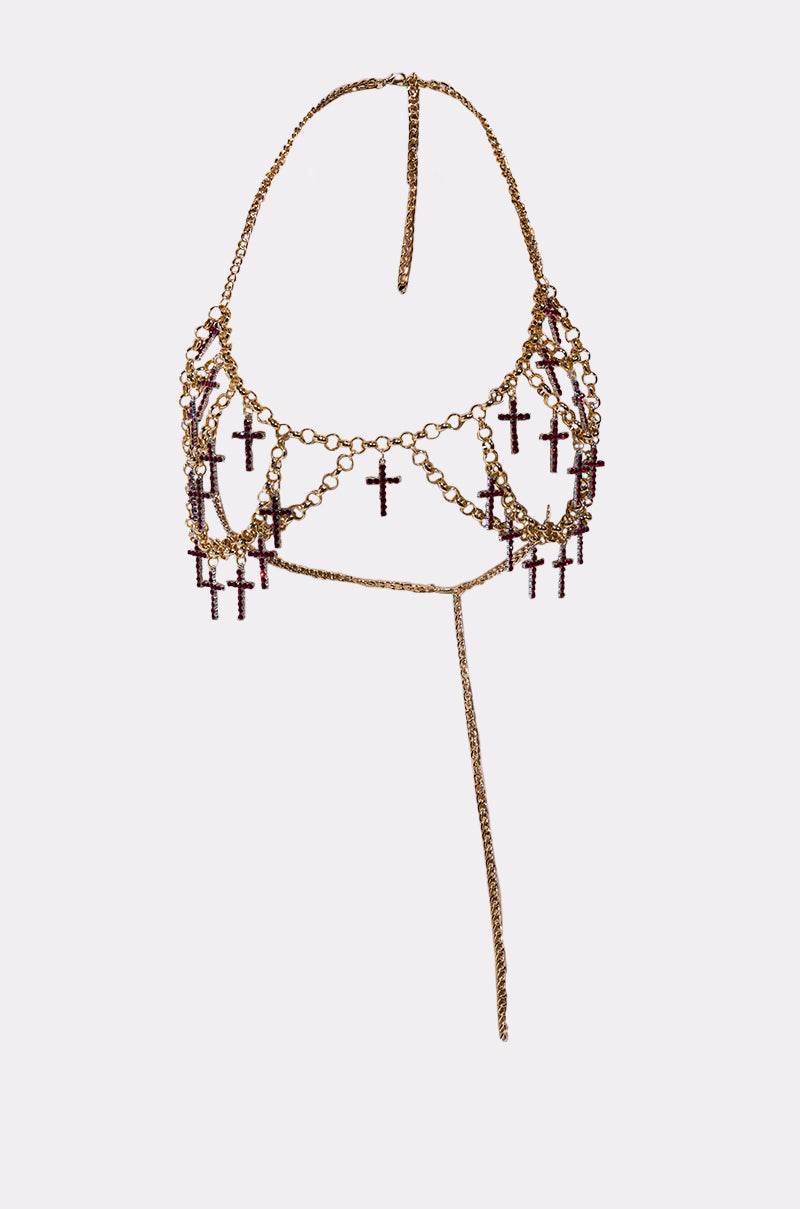 The HOLY CROSS BODY CHAIN is a gold chain halter top body jewelry piece adorned with rhinestone cross pendants and a long central chain that elegantly drapes over the chest and neck.