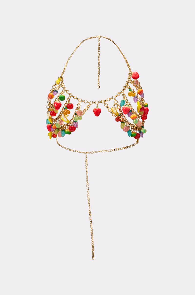 The TASTE ME FRUITY BODY CHAIN is a gold chain bikini top with colorful fruit-shaped beads and a red strawberry charm, featuring a front-attached chain—perfect as a fun and vibrant accessory for music festivals. 7
