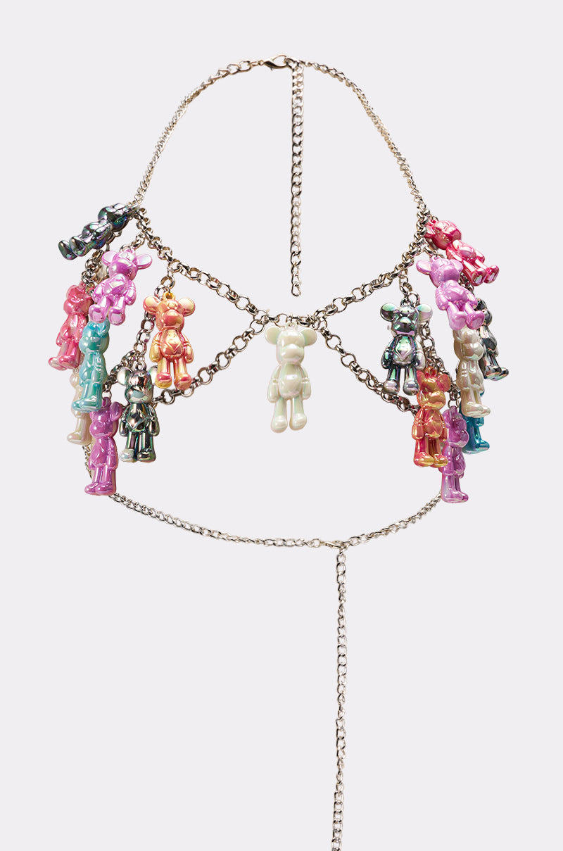 The BEARY CUTE BODY CHAIN is a silver halter-style harness with playful teddy bear charms in pink, purple, green, orange, silver, and black—Y2K-inspired and arranged in two rows with a center bear charm. 11