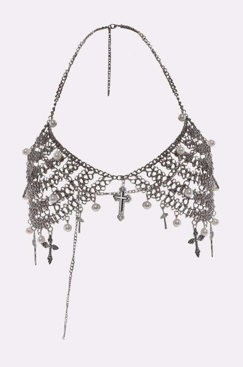 The CHARMED LIFE BODY CHAIN is a silver chainmail halter top with hanging cross charms and pearl beads, detailed metalwork, and a delicate neck chain—making it the perfect statement piece for festival jewelry.