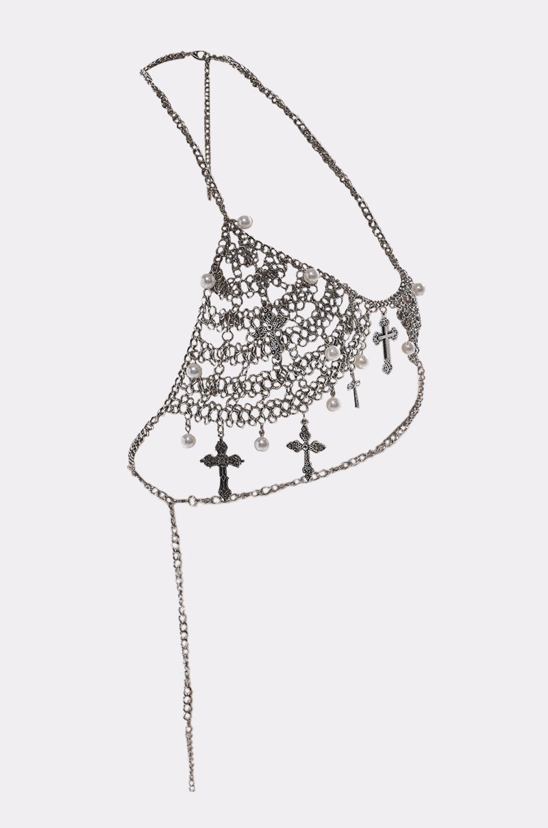 The CHARMED LIFE BODY CHAIN is a silver chainmail bra with pearl accents, dangling cross charms, and a layered asymmetrical design—ideal for gothic jewelry lovers.