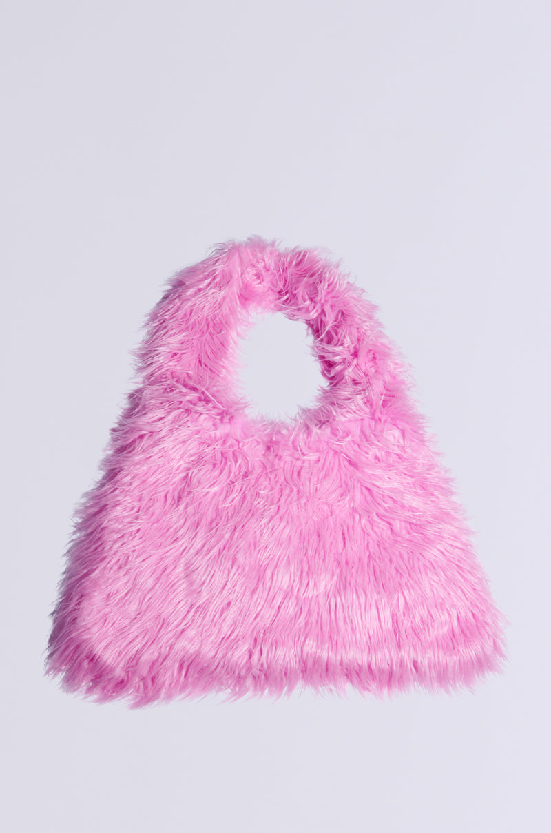 The I LOVE YOU FAUX FUR OVERSIZED TOTE is a fluffy bubblegum pink handbag featuring a circular handle. It showcases a soft, faux fur texture and maintains a simple, rounded design against a plain background.