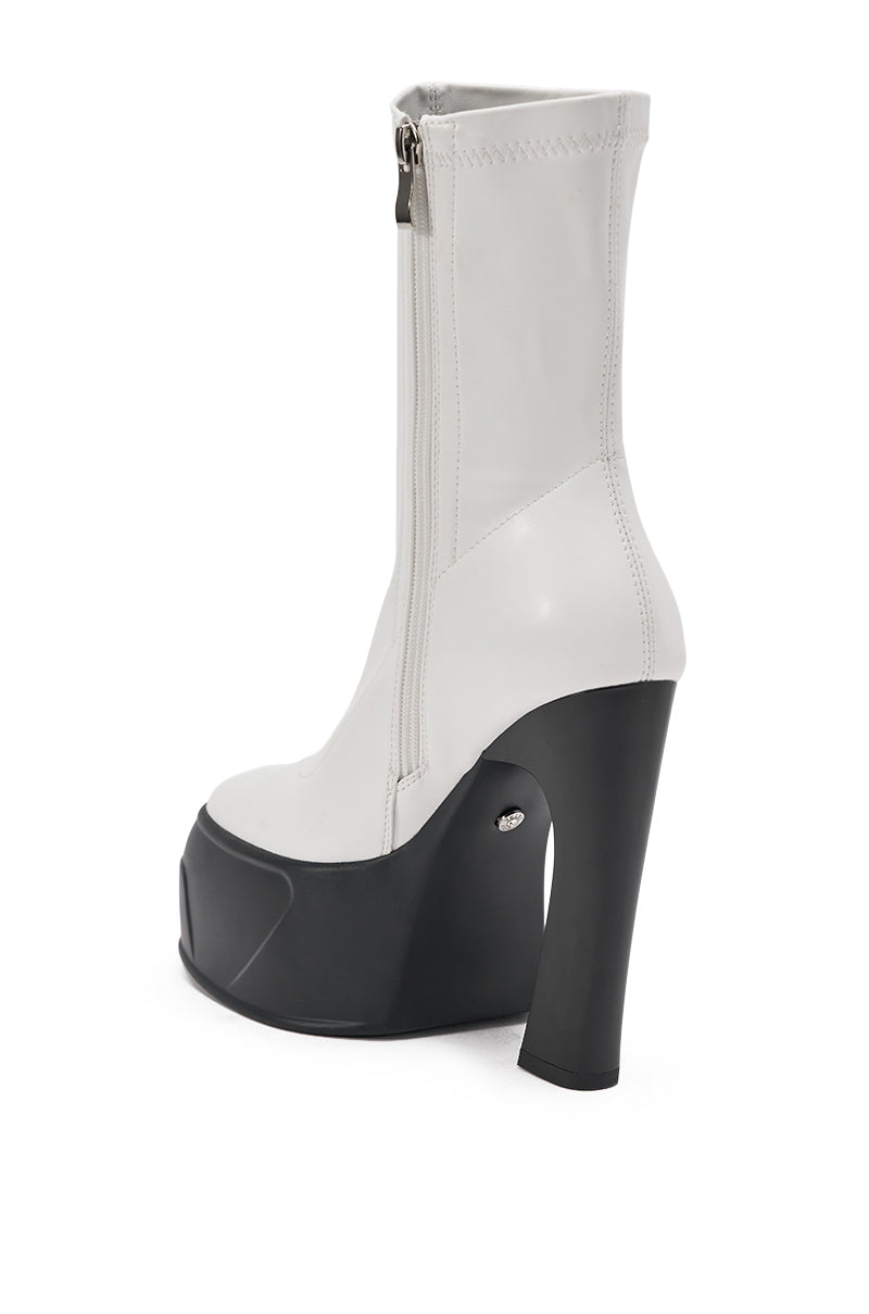 The AKIRA GOLD OBSIDIAN WHITE CHUNKY PLATFORM BOOTIE, featuring a side zipper, high block heel, and thick black sole, is shown against a plain white background. 6
