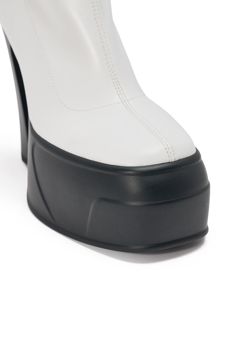 A close-up of the AKIRA GOLD OBSIDIAN WHITE CHUNKY PLATFORM BOOTIE featuring white faux leather, bold vertical stitching, and a thick black chunky platform sole. 7