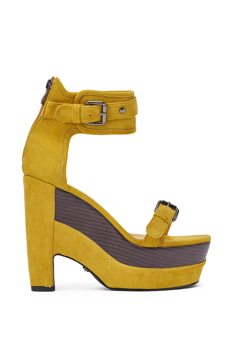 The AZALEA WANG OBVIOUS MUSTARD FAUX SUEDE WEDGE SANDAL showcases statement buckle straps, an ankle strap with buckle, a high platform sole, and a dark wooden-look wedge. 3