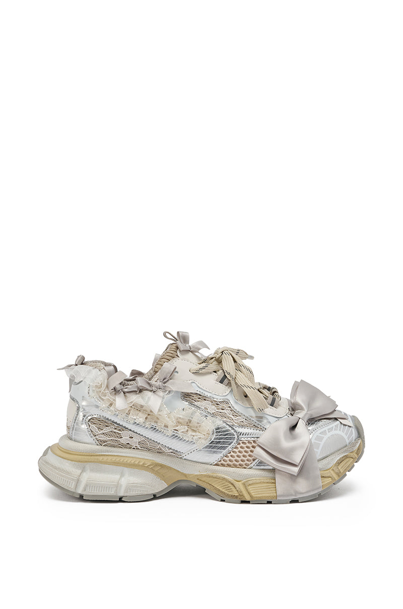 The AZALEA WANG OCTAVIA White Bow Embellished Chunky Sneaker features a coquette style with chunky platforms, distressed details, layered mesh panels, and decorative satin bows on the toes and laces in shades of beige, white, and light gray. 4