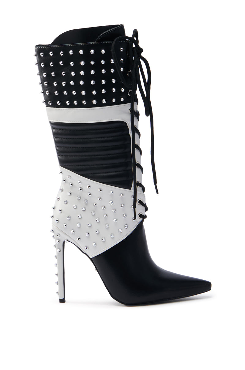 The AZALEA WANG OCTOBI BLACK AND WHITE STILETTO BOOT boasts a faux leather upper, pointed toe, silver studs, and front lacing for a bold, edgy look.