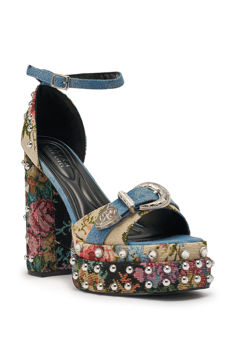 The AKIRA GOLD ODE DENIM MULTI CHUNKY RHINESTONE SANDAL features a high chunky block heel, floral tapestry, denim straps, ankle strap with silver buckle, plus pearl and rhinestone accents for bold western-inspired style. 4