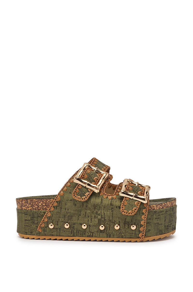The AZALEA WANG OHKAY GREEN FLATFORM STUD EMBELLISHED SLIP ON SANDAL features an olive green design, two gold buckles, zigzag stitching, gold rivets on the sole, and a textured cork platform for chic style and lift. 3